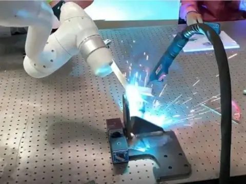 bracket being welded with a smaller cobot